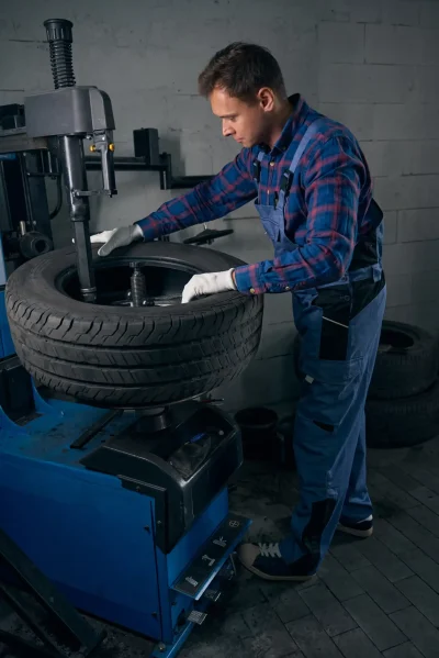 A man getting the tire out of a car wheel.