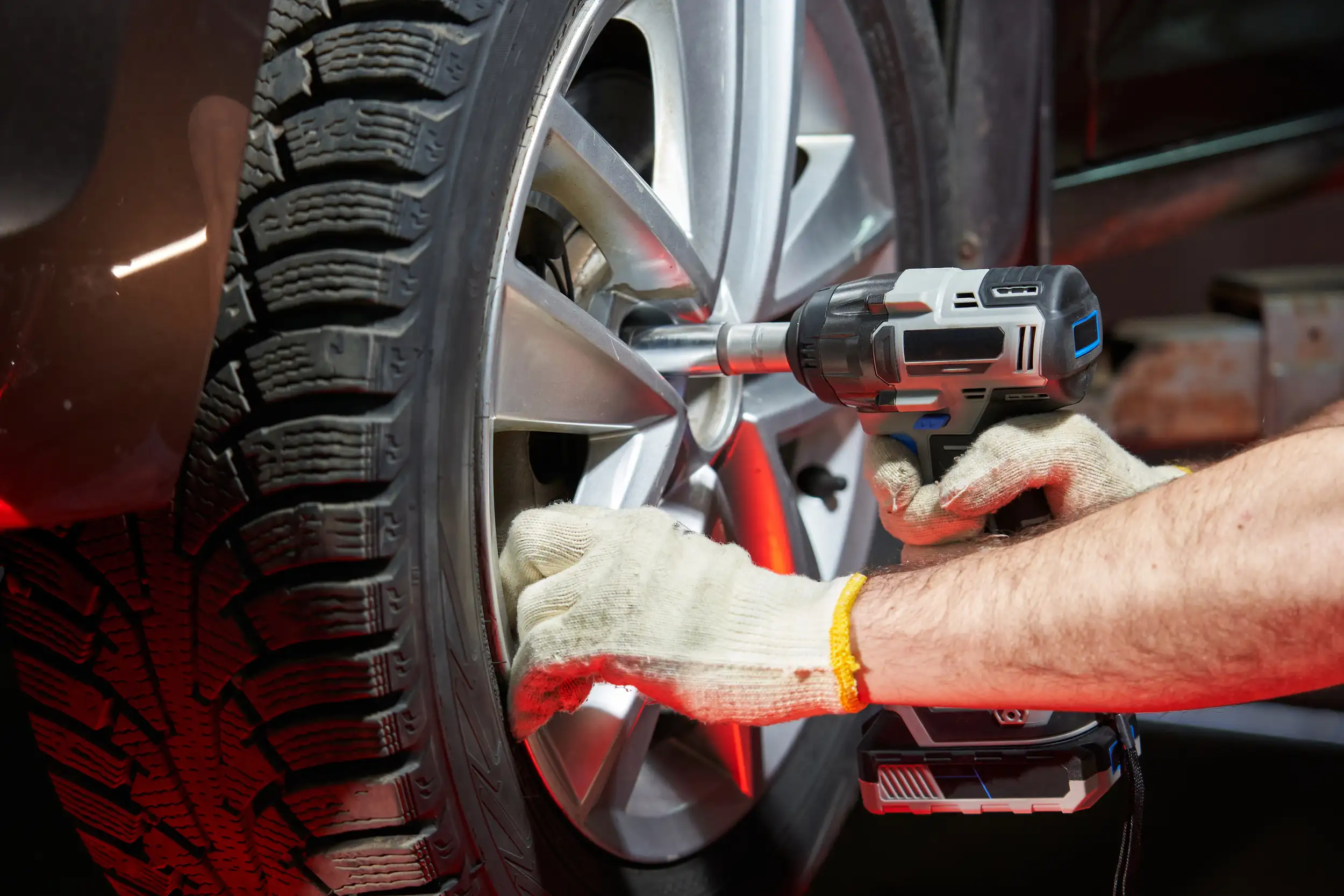 A car wheel getting out the bolts to inspect the problem.