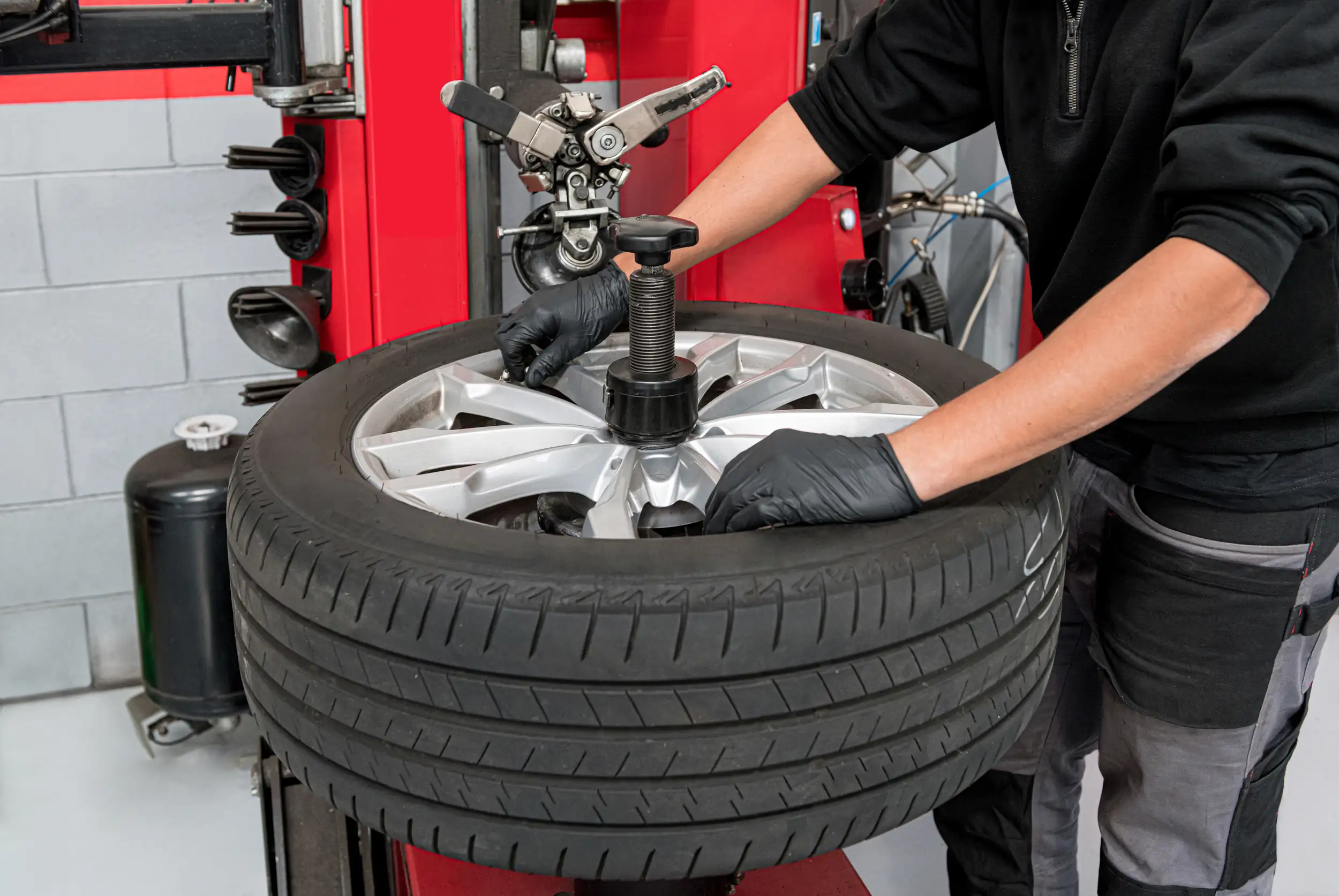 male operator dismantling a tire for repair.
